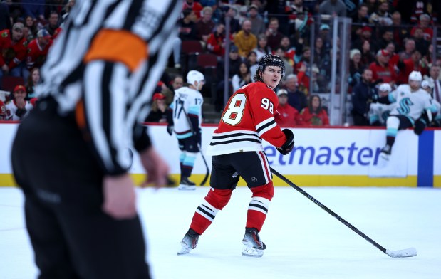 Chicago Blackhawks center Connor Bedard (98) argues with a referee after Bedard thought he was interfered with on a play in the third period of a game against the Seattle Kraken at the United Center in Chicago on Nov. 20, 2025. The referees called an unsportsmanlike conduct on Bedard for arguing the call. (Chris Sweda/Chicago Tribune)