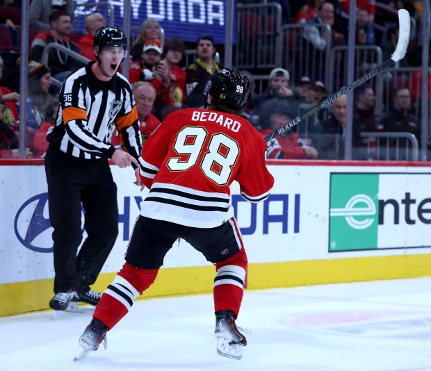 Chicago Blackhawks center Connor Bedard (98) argues with a referee after Bedard thought he was interfered with on a play in the third period of a game against the Seattle Kraken at the United Center in Chicago on Nov. 20, 2025. The referees called an unsportsmanlike conduct on Bedard for arguing the call. (Chris Sweda/Chicago Tribune)