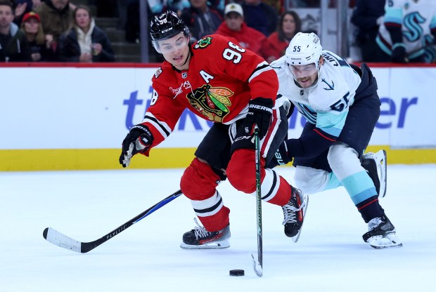 Chicago Blackhawks center Connor Bedard (98) skates down the ice before failing to score as Seattle Kraken defenseman Ryan Lindgren (55) trails on the play in the third period of a game at the United Center in Chicago on Nov. 20, 2025. (Chris Sweda/Chicago Tribune)