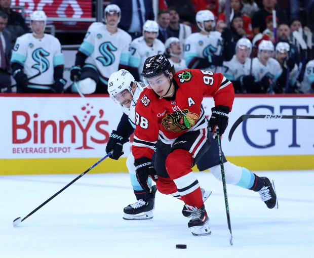 Chicago Blackhawks center Connor Bedard (98) skates down the ice before failing to score as Seattle Kraken defenseman Ryan Lindgren (55) trails on the play in the third period of a game at the United Center in Chicago on Nov. 20, 2025. (Chris Sweda/Chicago Tribune)
