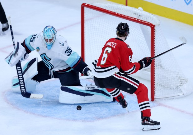 Chicago Blackhawks defenseman Sam Rinzel (6) is unable to score on Seattle Kraken goaltender Joey Daccord (35) in the second period of a game at the United Center in Chicago on Nov. 20, 2025. (Chris Sweda/Chicago Tribune)