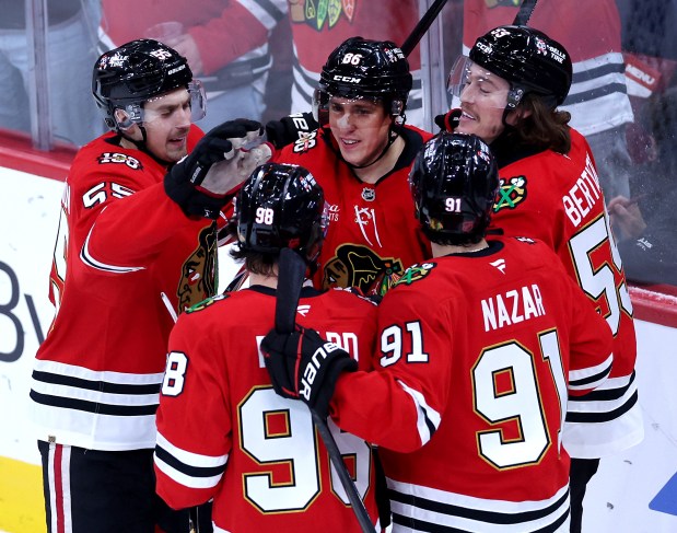 Chicago Blackhawks center Teuvo Teräväinen, center top, celebrates with teammates after scoring a goal in the second period against the Kraken on Nov. 20, 2025, at the United Center. (Chris Sweda/Chicago Tribune)