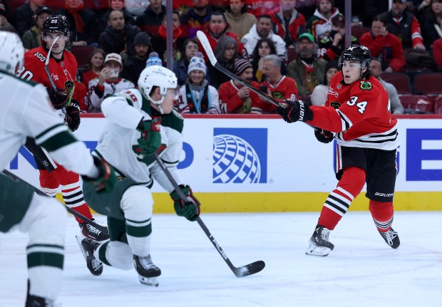 Chicago Blackhawks center Colton Dach (34) takes a shot in the first period of a game against the Minnesota Wild at the United Center in Chicago on Nov. 26, 2025. (Chris Sweda/Chicago Tribune)