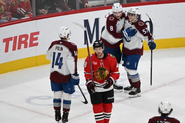 Colorado Avalanche's Cale Makar (8) celebrates with teammates Tristen Nielsen (57) and Jason Polin (14) after scoring a goal during the second period of an NHL hockey game against the Chicago Blackhawks, Sunday, Nov. 23, 2025, in Chicago. (AP Photo/Paul Beaty)