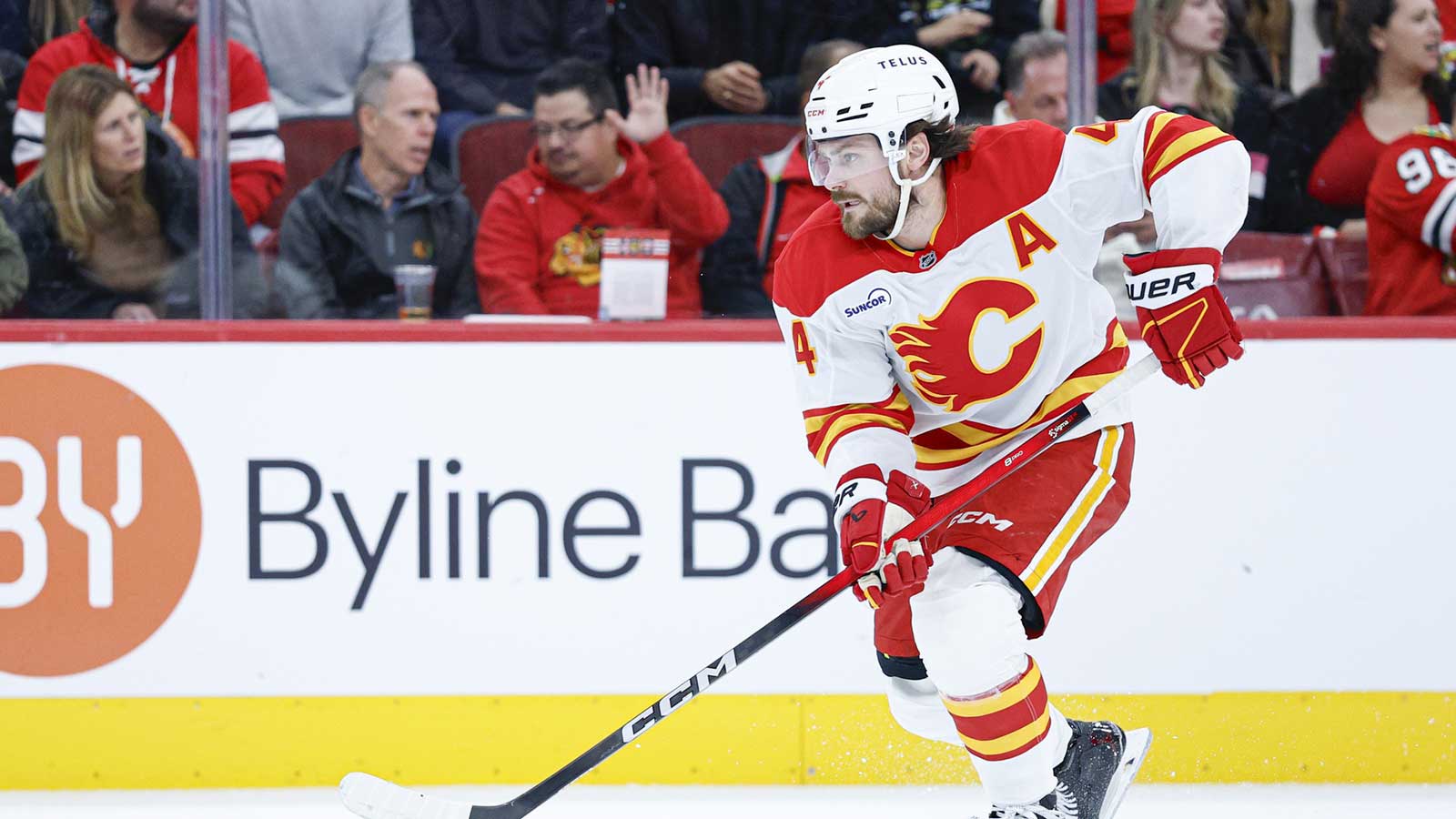 Calgary Flames defenseman Rasmus Andersson (4) controls the puck during the second period of NHL game against the Chicago Blackhawks at United Center. 