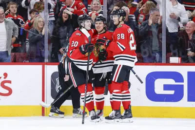 Nov 18, 2025; Chicago, Illinois, USA; Chicago Blackhawks center Connor Bedard (98) celebrates with teammates after scoring against the Calgary Flames during the second period at United Center.
