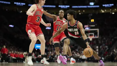 Jan 19, 2025; Portland, Oregon, USA; Portland Trail Blazers guard Scoot Henderson (00) drives past Chicago Bulls guard Josh Giddey (3) and guard Ayo Dosunmu (11) during the second half at Moda Center.