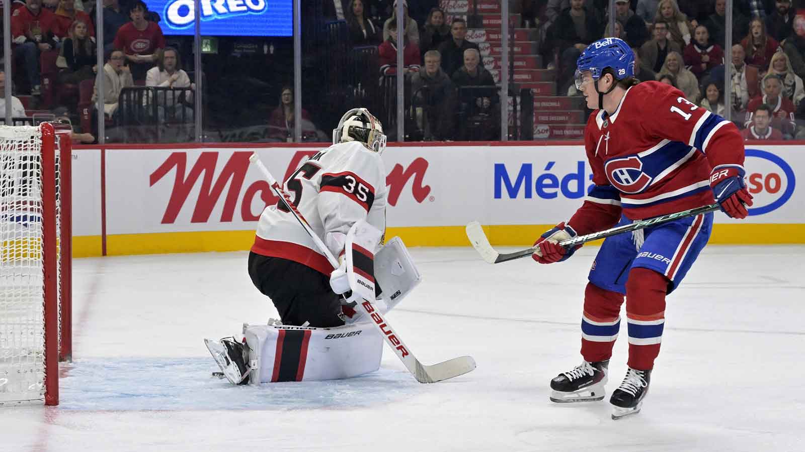 Montreal Canadiens forward Cole Caufield (13) scores a goal against Ottawa Senators goalie Linus Ullmark (35) during the first period at the Bell Centre. 