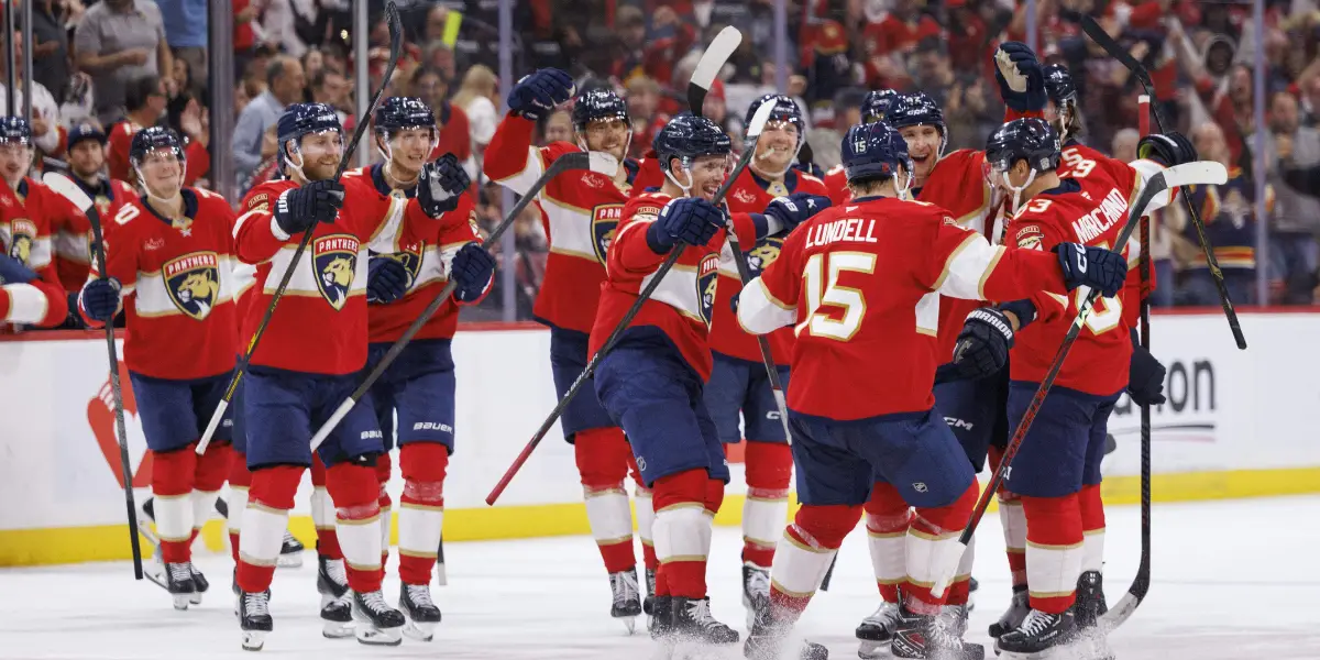 Brad Marchand celebrates 1k points with his teammates.