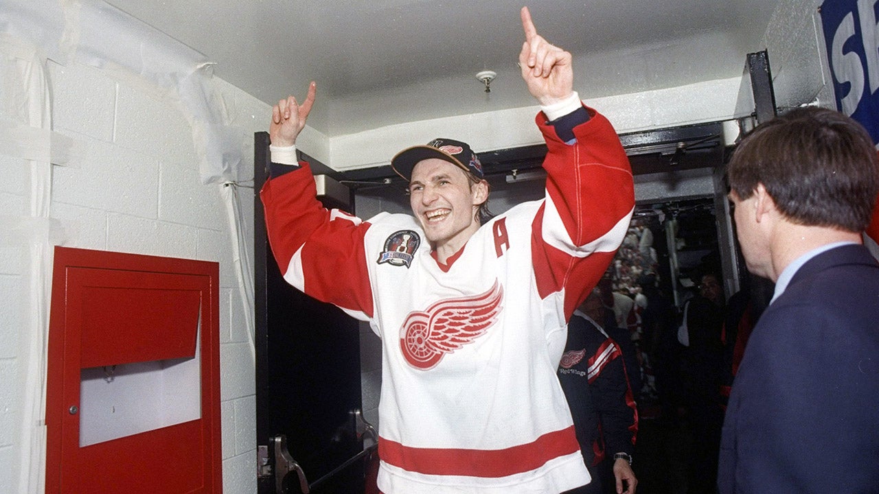 Detroit Red Wings center Sergei Fedorov holds up his arms as he walks into the locker room at the Joe Louis Arena in Detroit, Michigan. The Red Wings won the game 2-1.