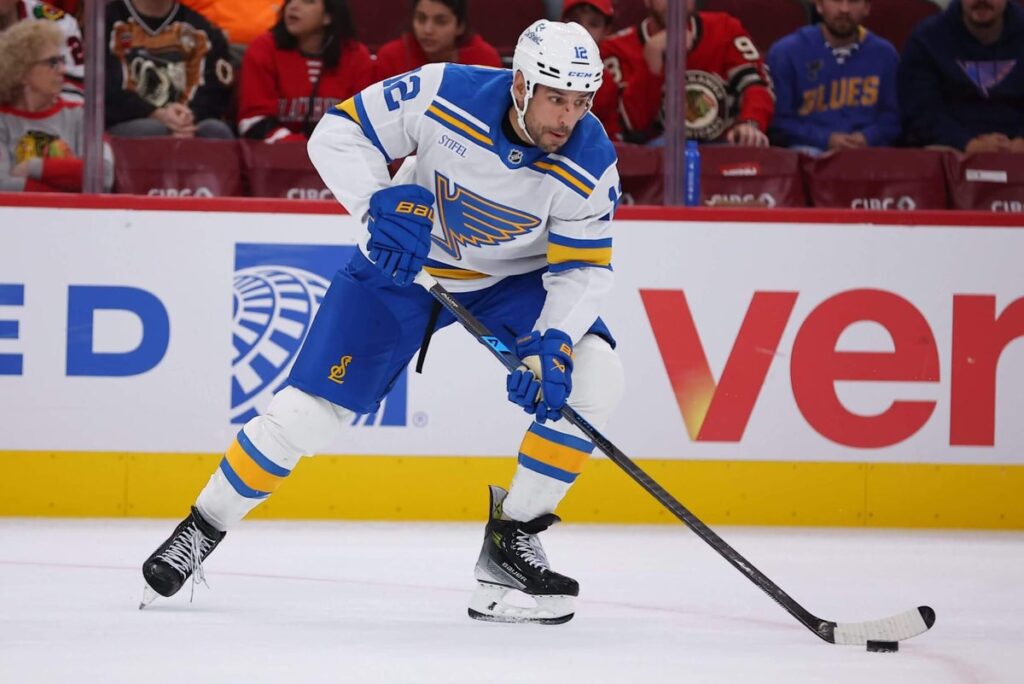 Milan Lucic controls the puck during the third period of a preseason game.