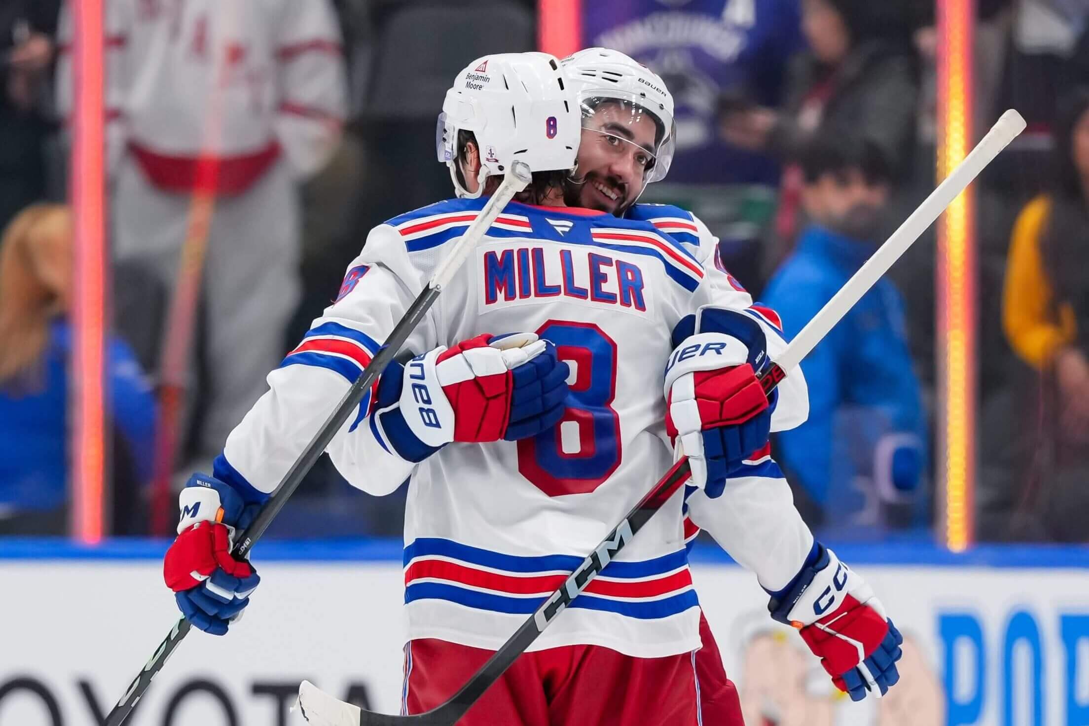 J.T. Miller, facing away, and Mika Zibanejad embrace after a win over the Canucks in October.