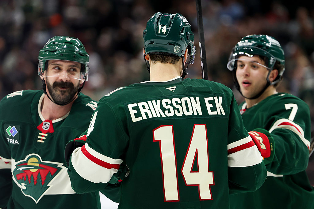 ST PAUL, MINNESOTA - NOVEMBER 15: Jake Middleton #5, Joel Eriksson Ek #14 and Brock Faber #7 of the Minnesota Wild react after their team scored in the third period against the Anaheim Ducks at Grand Casino Arena on November 15, 2025 in St Paul, Minnesota. (Photo by Ellen Schmidt/Getty Images)