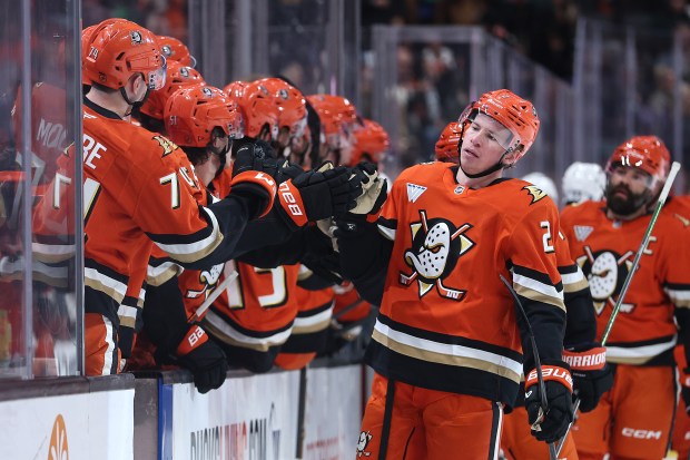 The Ducks’ Jackson Lacombe is congratulated at the bench after...