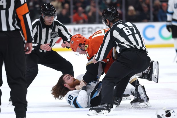 The Ducks’ Ross Johnston (44) throws the Utah Mammoth’s Liam...