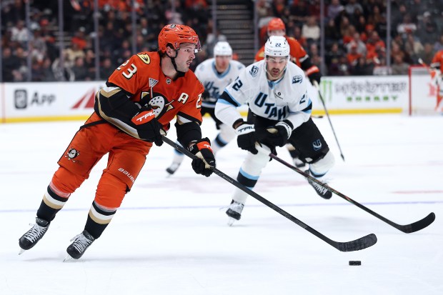 The Ducks’ Mason McTavish controls the puck as the Utah...