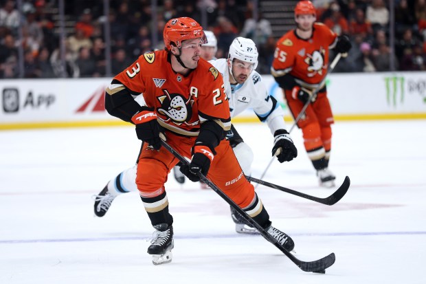The Ducks’ Mason McTavish controls the puck as the Utah...
