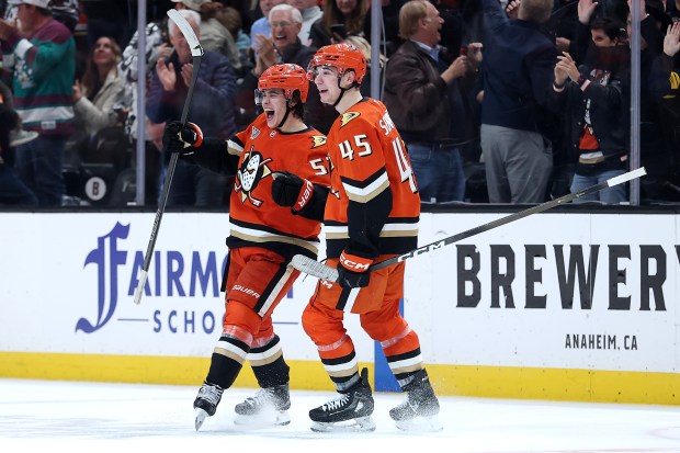The Ducks’ Beckett Sennecke, right, congratulates Olen Zellweger after his...