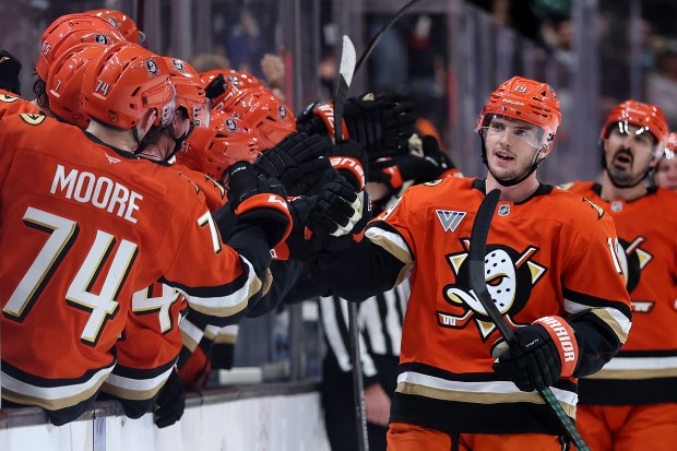The Ducks’ Troy Terry is congratulated at the bench after...