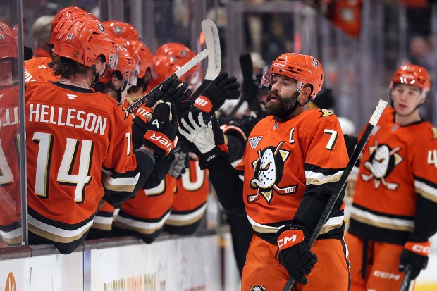 Ducks defenseman Radko Gudas is congratulated at the bench after...