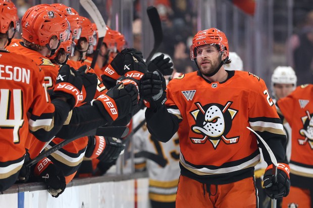The Ducks’ Jansen Harkins is congratulated at the bench after...