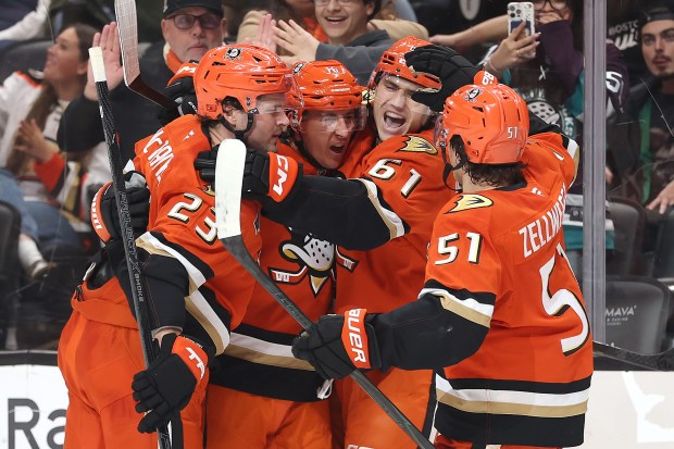 The Ducks’ Olen Zellweger (51), Mason McTavish (23) and Cutter...