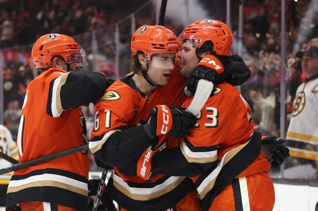 The Ducks’ Cutter Gauthier (61) congratulates Mason McTavish, right, after...