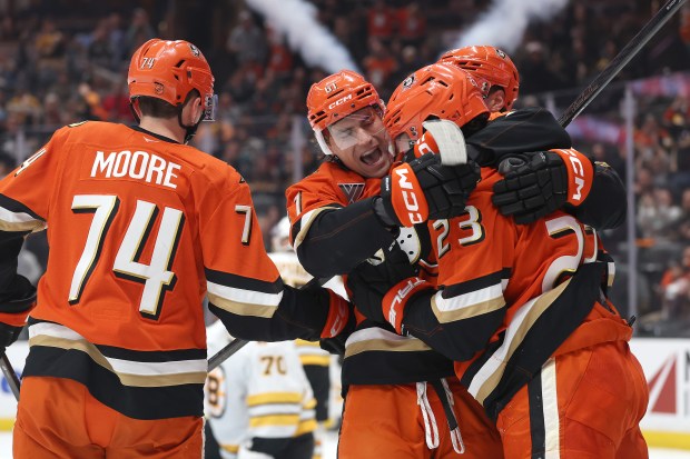 The Ducks’ Cutter Gauthier (61) and Ian Moore (74) are...