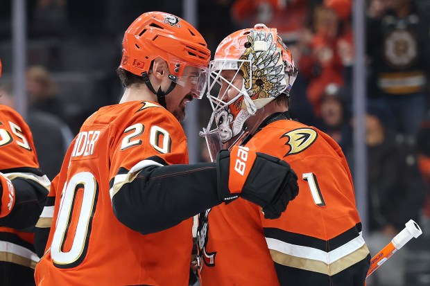 The Ducks’ Chris Kreider, left, and goaltender Lukas Dostal celebrate...