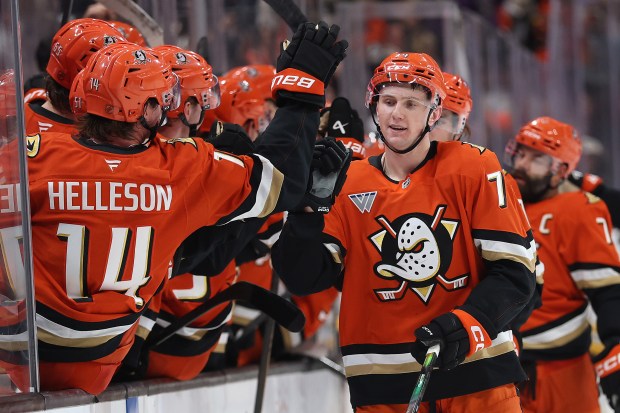 The Ducks’ Ian Moore is congratulated at the bench after...