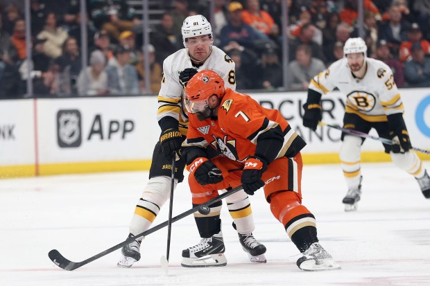 The Ducks’ Radko Gudas, front, collides with the Boston Bruins’...