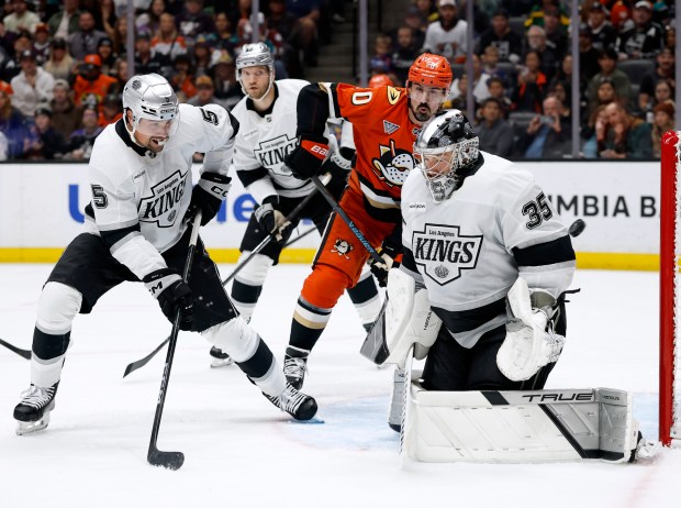 Kings goaltender Darcy Kuemper, right, reacts to his save in...