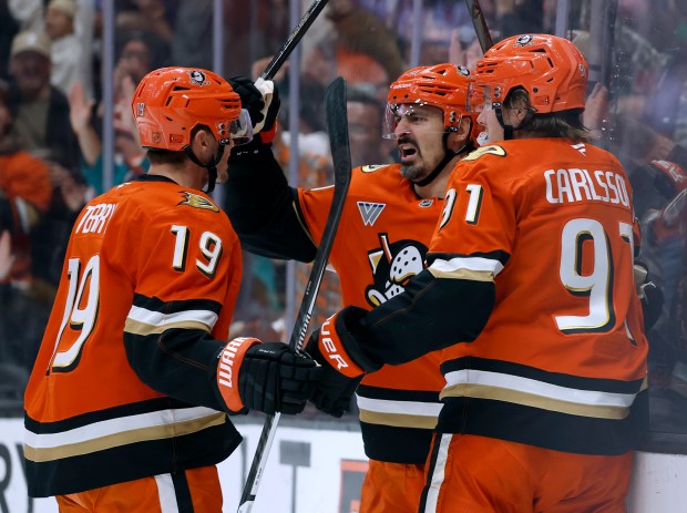 The Ducks’ Chris Kreider, center, celebrates his power-play goal with...