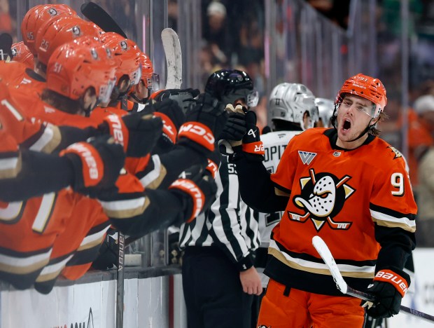 The Ducks’ Leo Carlsson, right, celebrates with the bench after...
