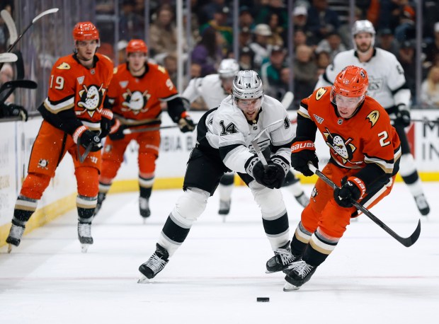 The Kings’ Alex Laferriere (14) checks the Ducks’ Jackson Lacombe,...