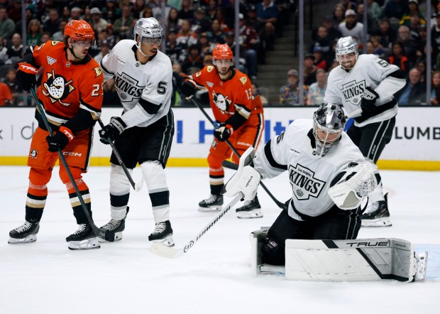 Kings goaltender Darcy Kuemper, far right, makes a save in...