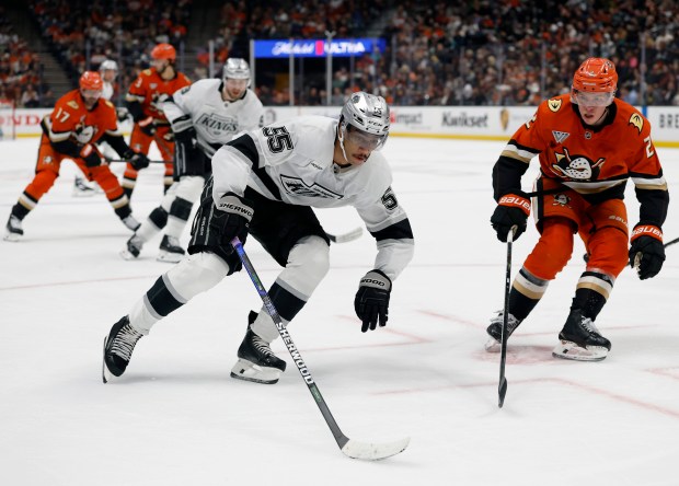 The Kings’ Quinton Byfield, left, skates in front of the...