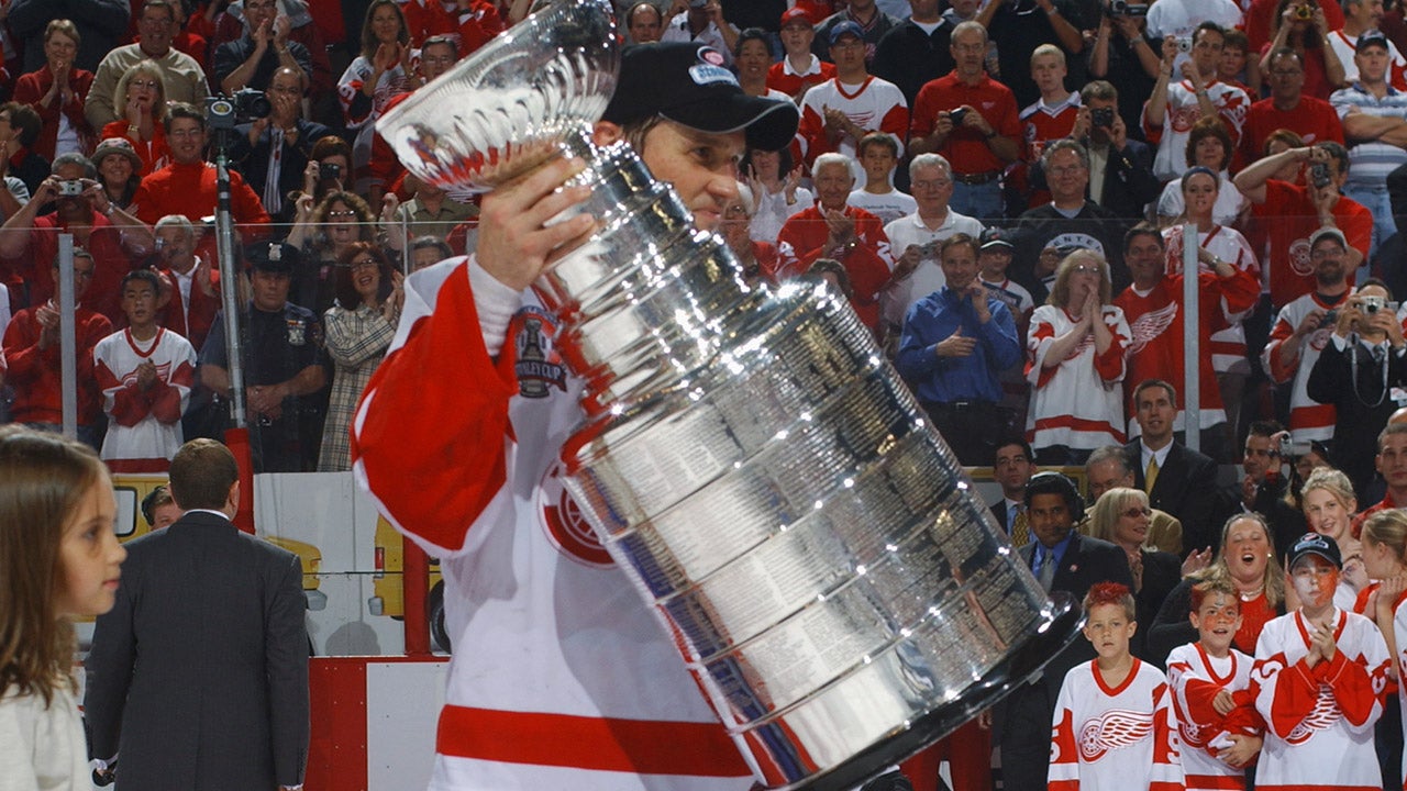 Steve Yzerman #19 of the Detroit Red Wings is presented with the Stanley Cup after defeating the Carolina Hurricanes during Game 5 of the 2002 NHL Stanley Cup Final. (Dave Sandford/Getty Images/NHLI)