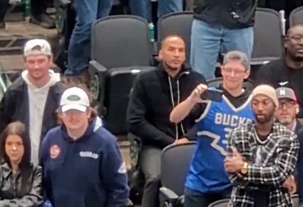 A picture of Nico Harrison sitting in the stands inside the American Airlines Center