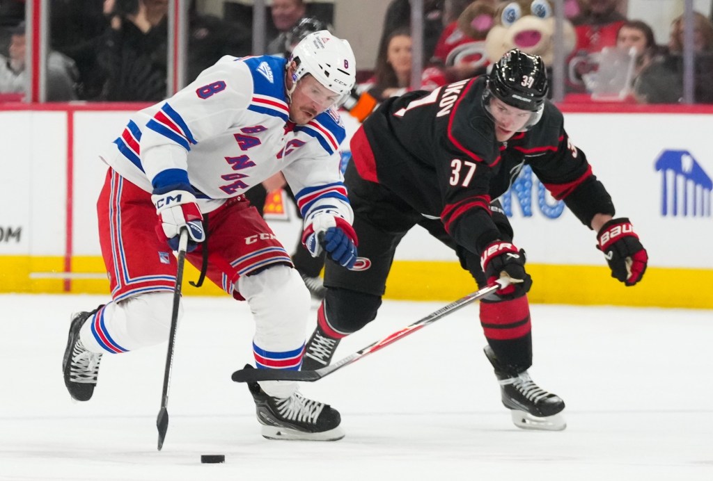 J.T. Miller skates with the puck past Andrei Svechnikov during the second period of the Rangers' 4-2 road win over the Hurricanes on Nov. 26, 2025.