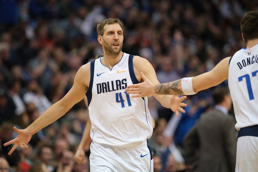 Dallas Mavericks forward Dirk Nowitzki (41) celebrates with forward Luka Doncic (77) after...