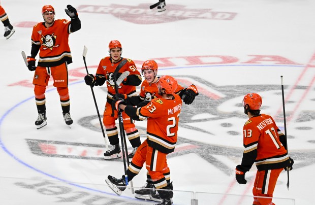 Ducks players, including Mason McTavish (23) celebrate after their 5-4...