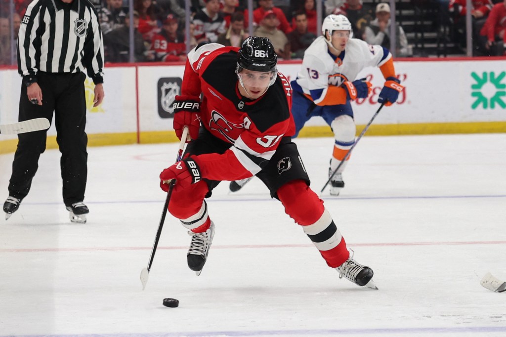 New Jersey Devils center Jack Hughes (86) skates with the puck against the New York Islanders during the second period at Prudential Center.