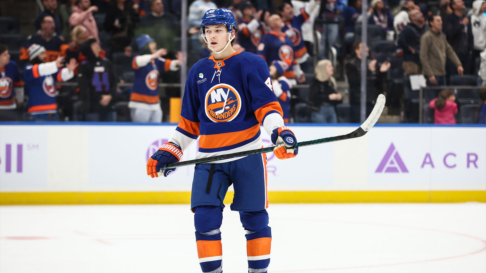 New York Islanders defenseman Matthew Schaefer (48) and Boston Bruins right wing David Pastrnak (88) battle for control of the puck in the third period at UBS Arena.