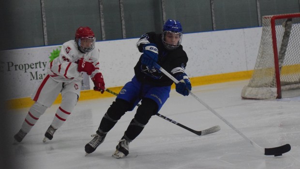 Junior Owen Wright (black) had a goal and an assist for Carlson in their eventual 3-3 tie vs Grosse Ile on Nov 26, 2025. (ALEXANDER MULLER -- MediaNews Group)