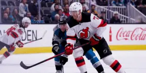 Dougie Hamilton fights for the puck against the San Jose Sharks.