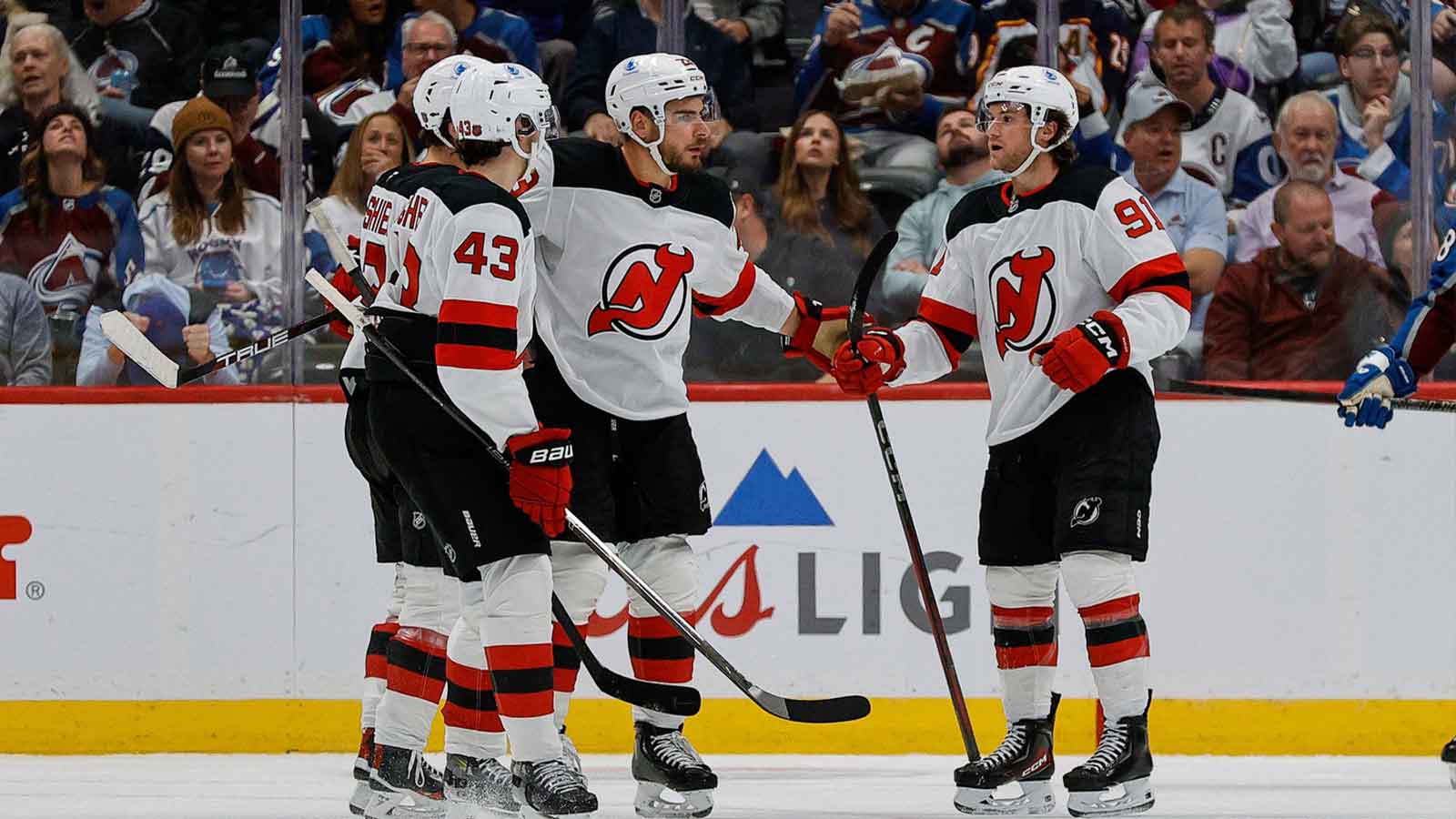 Jersey Devils center Dawson Mercer (91) celebrates his goal with defenseman Luke Hughes (43) and center Nico Hischier (13) and right wing Timo Meier (28) in the second period against the Colorado Avalanche at Ball Arena. 