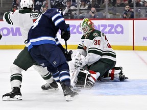 Minnesota Wild goaltender Jesper Wallstedt makes a save on Winnipeg Jets' Gustav Nyquist. Fred Greenslade/The Canadian Press