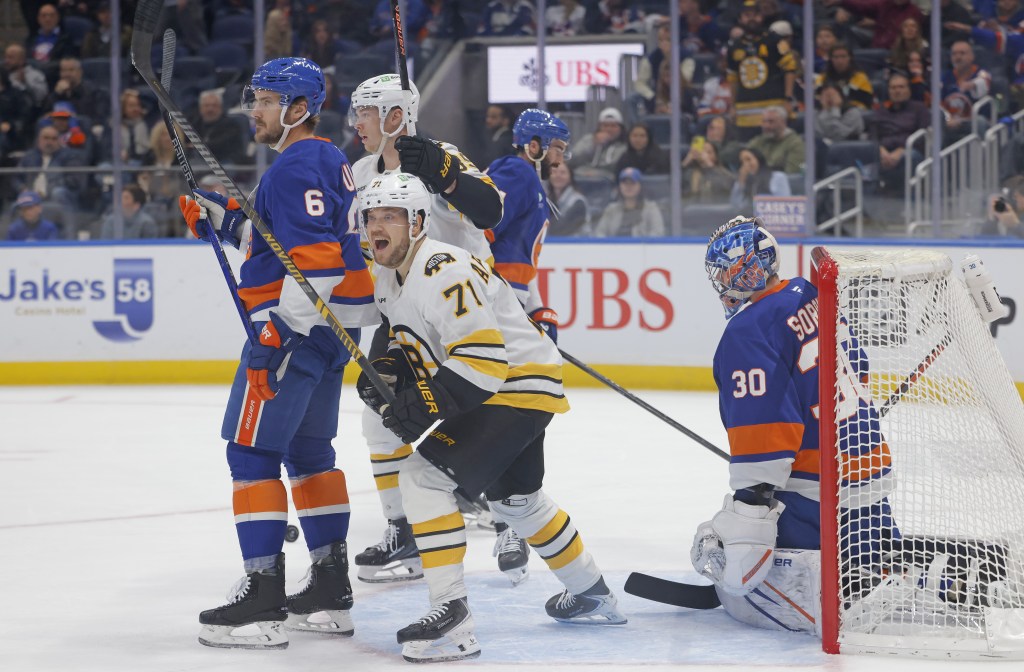 Viktor Arvidsson (71) celebrates Pavel Zacha's power play goal during the Bruins shootout win over the Islanders.
