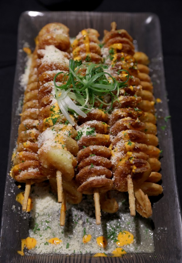 Potato wedges are served on skewers during the “Taste of...